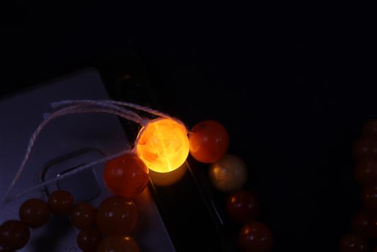 A single strand amber bead necklace, gross weight 28 grams and two other necklaces.